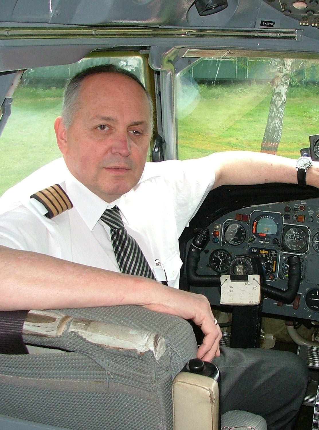 Graham, sitting in the cockpit of an aircraft